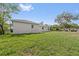 Backyard featuring a spacious lawn and the rear facade of the house at 560 Sumner Ave, Orange City, FL 32763