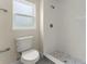 A bright bathroom features a white tiled shower and modern fixtures at 560 Sumner Ave, Orange City, FL 32763