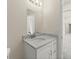 Bathroom with granite vanity, white cabinets, and modern fixtures at 560 Sumner Ave, Orange City, FL 32763