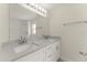An elegant bathroom features granite counters, double sinks, and white cabinetry at 560 Sumner Ave, Orange City, FL 32763