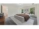 A styled bedroom featuring neutral tones, elegant furniture, and natural lighting at 560 Sumner Ave, Orange City, FL 32763