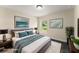 Staged bedroom with a large bed, stylish lamps and modern artwork at 560 Sumner Ave, Orange City, FL 32763