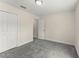 Bright bedroom features plush gray carpeting and a spacious closet at 560 Sumner Ave, Orange City, FL 32763