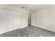 Bright bedroom features plush gray carpeting and a spacious closet at 560 Sumner Ave, Orange City, FL 32763