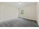 An empty bedroom featuring neutral walls and modern gray carpeting at 560 Sumner Ave, Orange City, FL 32763
