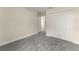 Neutral bedroom with gray carpet and closet with white bi-fold doors at 560 Sumner Ave, Orange City, FL 32763