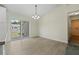 Bright dining space with tile floors, a chandelier, and sliding doors at 560 Sumner Ave, Orange City, FL 32763