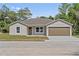 Charming single-story home featuring a well-maintained lawn and a two-car garage at 560 Sumner Ave, Orange City, FL 32763
