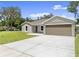 Charming one-story home with a spacious driveway, a two-car garage, and a well-maintained lawn at 560 Sumner Ave, Orange City, FL 32763