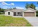 Charming single-story home featuring a well-maintained lawn and a neutral color palette at 560 Sumner Ave, Orange City, FL 32763
