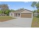 Inviting single-story home with a spacious driveway and well-manicured lawn at 560 Sumner Ave, Orange City, FL 32763