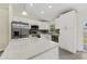 Stylish kitchen with stainless appliances, granite countertops, and white cabinetry for a crisp design at 560 Sumner Ave, Orange City, FL 32763