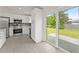 Bright kitchen with stainless steel appliances, white cabinets, and a sliding glass door to backyard at 560 Sumner Ave, Orange City, FL 32763