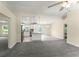 An open-concept floor plan seamlessly connects the spacious living area and adjacent kitchen with island seating at 560 Sumner Ave, Orange City, FL 32763