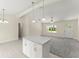 Bright living room with gray carpet, island, and ample natural light beaming in at 560 Sumner Ave, Orange City, FL 32763