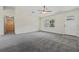Bright, spacious living room features plush carpeting and an entrance view at 560 Sumner Ave, Orange City, FL 32763