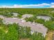 Aerial view of the community with townhomes nestled among mature trees, offering privacy and a tranquil atmosphere at 564 Mount Olympus Blvd, New Smyrna Beach, FL 32168