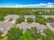 Aerial view showcasing the community's townhomes surrounded by lush greenery, providing a serene environment at 564 Mount Olympus Blvd, New Smyrna Beach, FL 32168