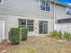 Private backyard with sliding glass doors, mature hedges, and lawn at 564 Mount Olympus Blvd, New Smyrna Beach, FL 32168