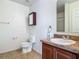 Neutral bathroom with tile floor, updated vanity, and wood-trimmed medicine cabinet at 564 Mount Olympus Blvd, New Smyrna Beach, FL 32168