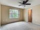 Bright bedroom with large window and doorway to the bathroom and shower at 564 Mount Olympus Blvd, New Smyrna Beach, FL 32168