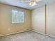 Bright bedroom with neutral walls, soft carpeting, and a large window at 564 Mount Olympus Blvd, New Smyrna Beach, FL 32168