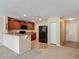 Well-lit kitchen features wood cabinets, modern appliances, and a breakfast bar for casual dining at 564 Mount Olympus Blvd, New Smyrna Beach, FL 32168