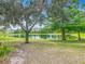Beautiful lake view with lush trees, showcasing a tranquil setting and reflective waters at 564 Mount Olympus Blvd, New Smyrna Beach, FL 32168