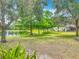Scenic lake view with lush trees and greenery, offering a tranquil setting for a relaxing neighborhood at 564 Mount Olympus Blvd, New Smyrna Beach, FL 32168