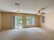 Spacious living room with sliding glass doors and large window, offering plenty of natural light at 564 Mount Olympus Blvd, New Smyrna Beach, FL 32168