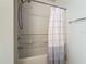 White shower with brushed nickel fixtures and gray and white striped curtain at 564 Mount Olympus Blvd, New Smyrna Beach, FL 32168