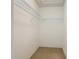 Spacious walk-in closet with adjustable wire shelving and neutral carpeting at 564 Mount Olympus Blvd, New Smyrna Beach, FL 32168