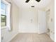 A bright bedroom with tile flooring, a ceiling fan, and a doorway leading to another room at 566 S Floyd Cir, Deltona, FL 32725