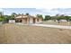 A single story home with a carport, shed, and spacious front yard at 566 S Floyd Cir, Deltona, FL 32725