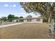 Inviting single-story home featuring a well-maintained lawn and mature tree at 566 S Floyd Cir, Deltona, FL 32725