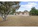 Cozy home with simple architectural lines surrounded by mature trees and green space at 566 S Floyd Cir, Deltona, FL 32725
