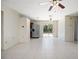 Open-concept living area with tile floors, ceiling fans, and a view of the backyard at 566 S Floyd Cir, Deltona, FL 32725