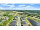 High aerial view of a community with a pond, showcasing its location near a highway and surrounding greenery at 6212 W Fallsgrove Ln, Port Orange, FL 32128