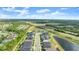 High aerial view of a community with a pond, showcasing its location near a highway and surrounding greenery at 6212 W Fallsgrove Ln, Port Orange, FL 32128