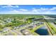 Elevated aerial view captures the community near a pond, highlighting neighborhood layout and proximity to local amenities at 6212 W Fallsgrove Ln, Port Orange, FL 32128