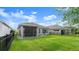 The well-manicured backyard includes a fenced-in perimeter, perfect for privacy and security at 6212 W Fallsgrove Ln, Port Orange, FL 32128