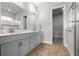 Modern bathroom with dual vanity, gray cabinets, quartz countertops, and walk-in shower at 6212 W Fallsgrove Ln, Port Orange, FL 32128