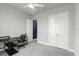 This bedroom features gray carpet, a white ceiling fan, and a closet with double doors at 6212 W Fallsgrove Ln, Port Orange, FL 32128