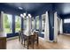 Bright dining room with a chandelier, large windows, hardwood floors, and white curtains at 6212 W Fallsgrove Ln, Port Orange, FL 32128
