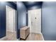 Welcoming entryway with a blue accent wall, modern console table, and light-colored flooring at 6212 W Fallsgrove Ln, Port Orange, FL 32128