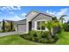 Charming single-story home with a well-manicured lawn, stone accents and a two-car garage at 6212 W Fallsgrove Ln, Port Orange, FL 32128
