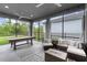 Inviting screened lanai featuring a pool table and comfortable seating for relaxation at 6212 W Fallsgrove Ln, Port Orange, FL 32128