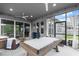 Relaxing screened in lanai with ceiling fans, a pool table and comfortable seating area at 6212 W Fallsgrove Ln, Port Orange, FL 32128