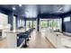 Open-concept living and kitchen area featuring wood floors and sliding glass doors to a patio at 6212 W Fallsgrove Ln, Port Orange, FL 32128