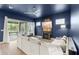Open-concept living area boasts wood floors and sliding glass doors to a screened in patio at 6212 W Fallsgrove Ln, Port Orange, FL 32128